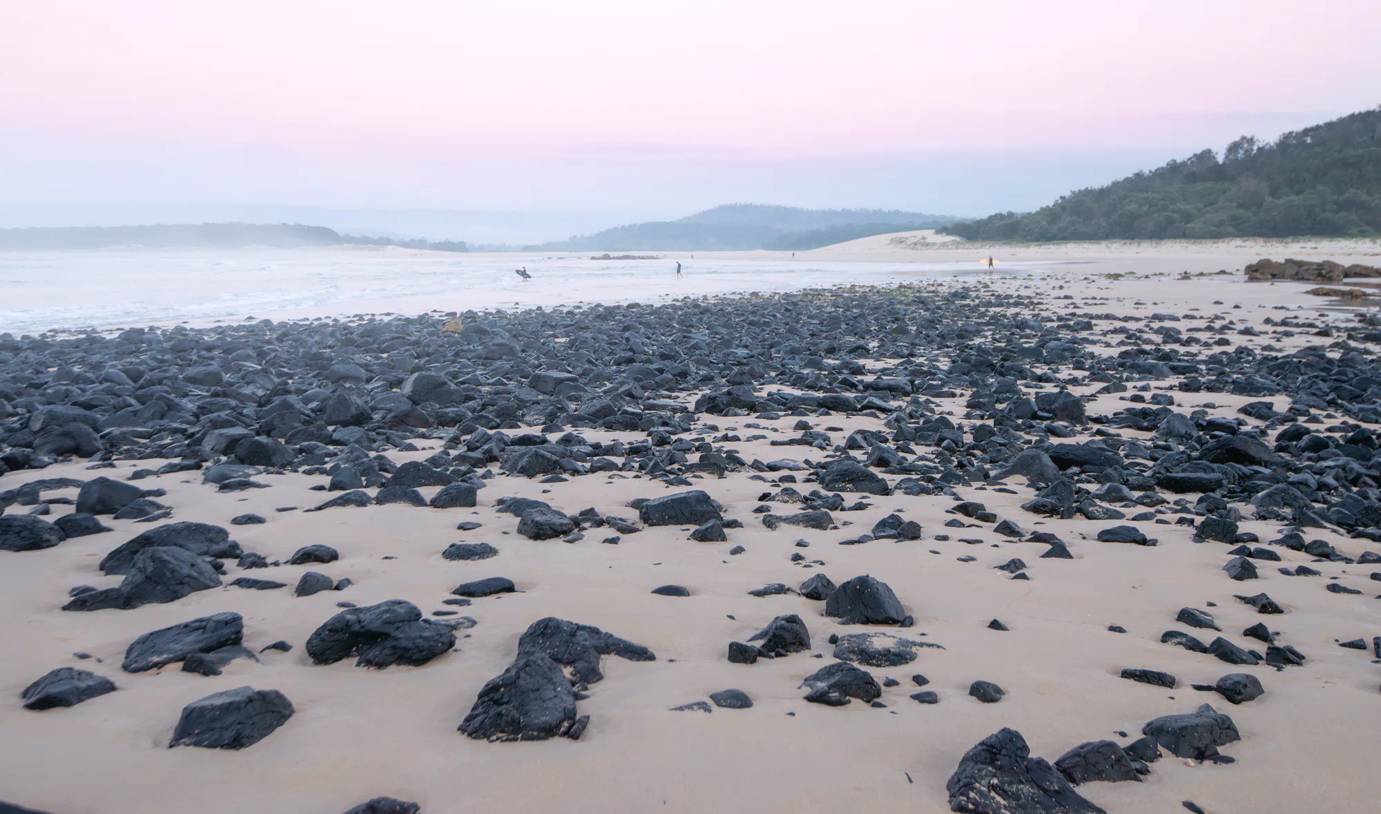 sunrise surfers walking